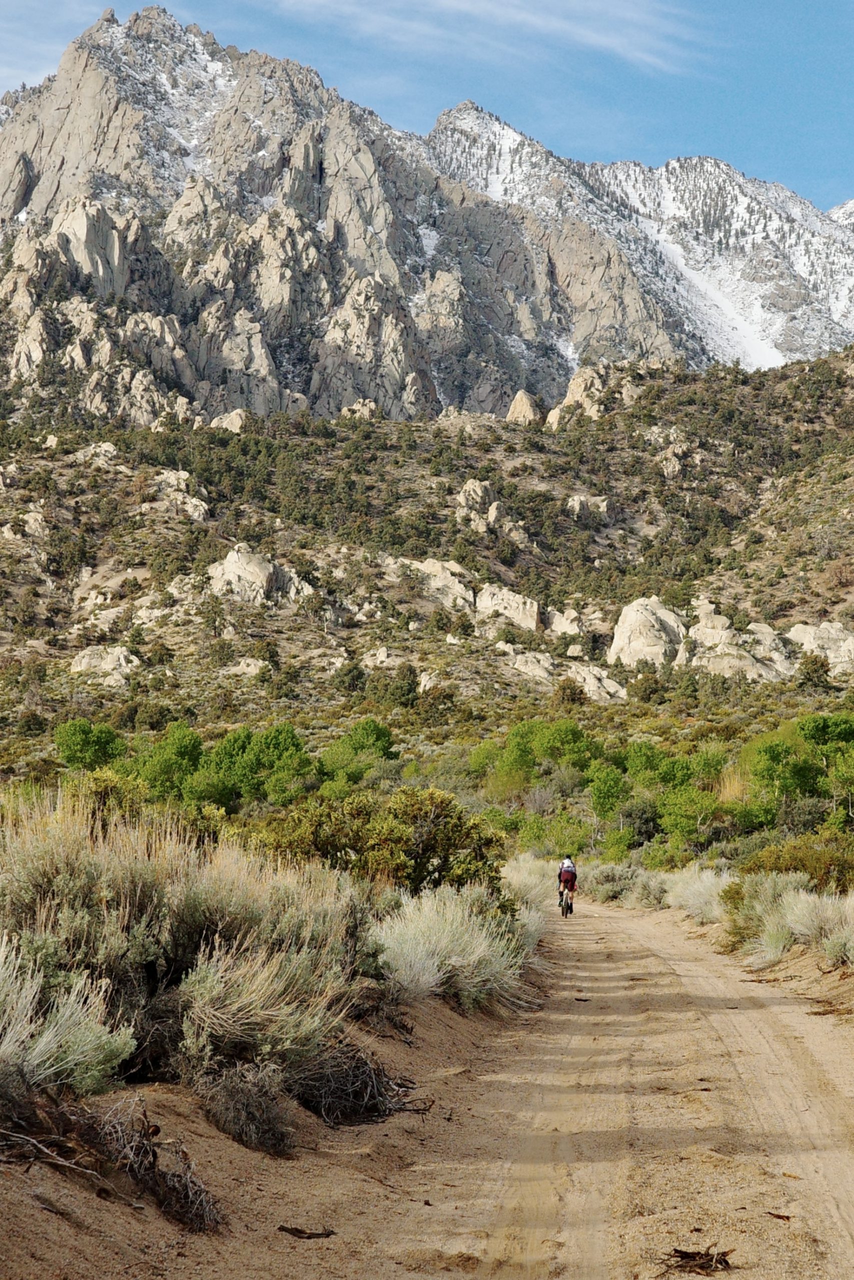 Dirt road leading pu to mountain with bicycle on road