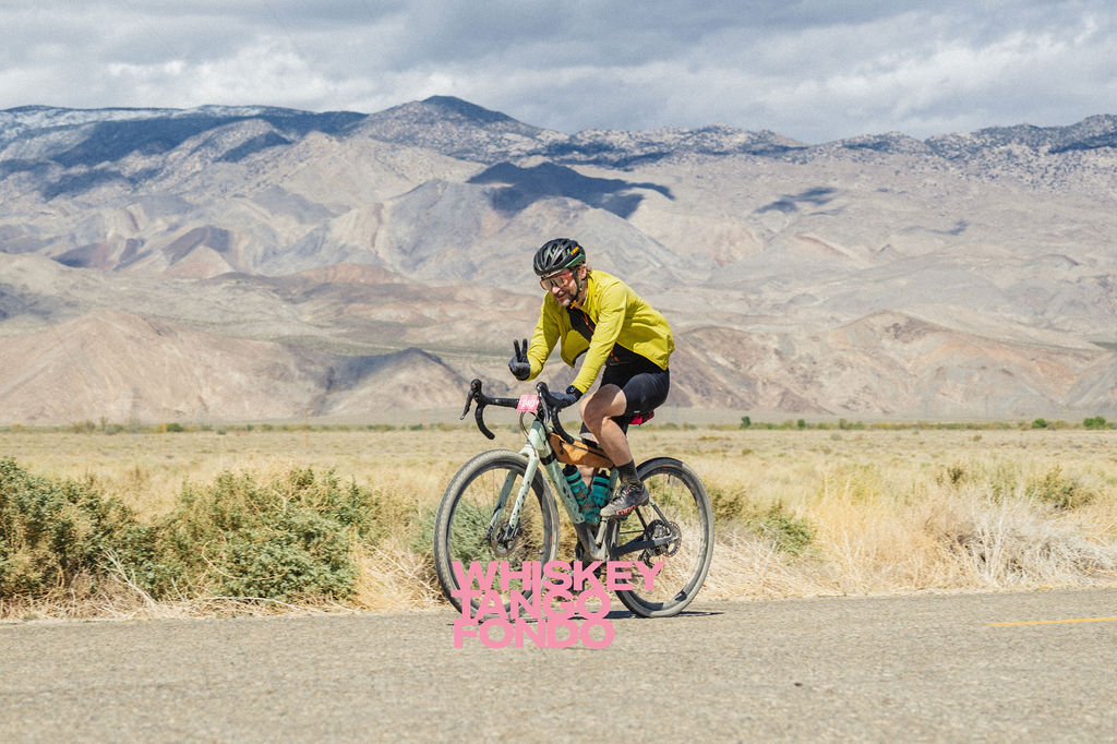 Photo of a tired cyclist giving a peace sign